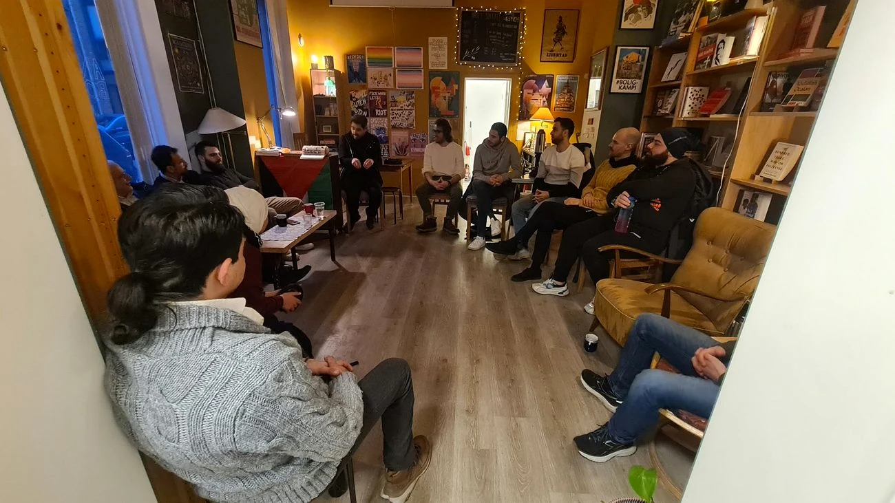 Participants seated in a circle during a dialogue meeting